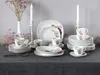 A table setting with a 30-piece dinnerware set featuring a floral orchid pattern. Produktbild-Vorschau