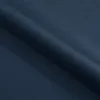 A close-up, angled view of dark blue fabric, likely upholstery, with soft lighting creating shadows and highlights. Náhľad obrázku produktu