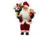 A Santa Claus figurine holding a teddy bear and a sack of gifts. Produktbild-Vorschau