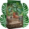 A bag of soil for houseplants, surrounded by large green leaves. Náhľad obrázku produktu