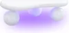 Close-up view of the underside of a white couch table with three spherical legs, illuminated by purple light. Náhled obrázku produktu