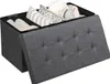 A dark gray storage ottoman with its lid open, revealing compartments filled with pillows and rolled items. Anteprima dell’immagine prodotto