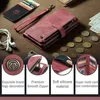 A flat lay of a red wallet case for a phone, surrounded by accessories like earbuds, cards, coins, and cash. Produktbild-Vorschau