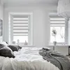 A bedroom scene with a bed and two windows. Produktbild-Vorschau