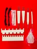 A collection of knitting tools laid out on a red background. Produktbild-Vorschau