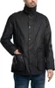 A man wearing a black jacket and blue jeans. Produktbild-Vorschau