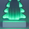 A close-up of a decorative LED Christmas tree with an infinity mirror effect, glowing green. Produktbild-Vorschau