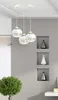 A modern interior scene with a pendant light fixture and decorative shelves. Podgląd zdjęcia produktu