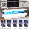A white high-gloss TV cabinet with blue LED lighting, shown in a living room setting. Below the cabinet are app screenshots demonstrating features. Náhľad obrázku produktu