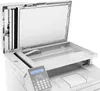 A close-up, slightly angled view of an open multifunction printer. Produktbild-Vorschau