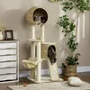 A cat tree with two cats is placed in a living room setting next to a dresser and a decorative plant. Podgląd zdjęcia produktu