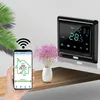 A hand holding a smartphone displaying a smart thermostat app, with a smart thermostat device and a vase of flowers on a shelf in the background. Náhled obrázku produktu