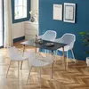 A dining set with four white chairs and a black table in a room with blue walls and a wooden floor. Voir les images du produit