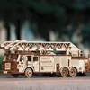 A wooden model fire truck with a ladder is displayed outdoors. Náhľad obrázku produktu