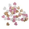 A scattered collection of small heart-shaped confetti pieces in pink, white, and wood grain. Produktbild-Vorschau