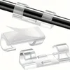 Durchsichtige selbstklebende Kabelclips, einer hält ein schwarzes Kabel, ein anderer mit abgezogener Rückseite Productafbeelding-voorbeeld