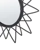 A close-up view of a black rattan sunburst mirror. Produktbild-Vorschau
