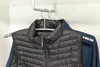 A black puffy vest and a blue jacket hang on hangers in a closet. Produktbild-Vorschau