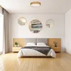 A bedroom scene with a bed, nightstands, and decorative mirrors on the wall. Produktbild-Vorschau