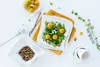 A flat lay of a white porcelain dinnerware set with food. Produktbild-Vorschau