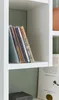 A close-up view of CDs on a shelf in a white bookcase. Produktbild-Vorschau