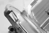 A close-up, black and white shot of a meat slicer. Náhľad obrázku produktu
