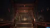 A dimly lit Japanese shrine with a torii gate and hanging decorations. Produktbild-Vorschau