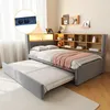 A bedroom setting with a bed and a pull-out trundle bed. Voir les images du produit