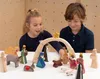 Two children are playing with a wooden nativity scene set. Produktbild-Vorschau