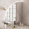 A vanity table with a mirror, flowers, and makeup products. Produktbild-Vorschau