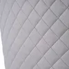 A close-up view of a quilted gray fabric surface. Náhľad obrázku produktu