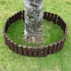 A brown plastic garden border is placed around the base of a tree trunk on a grassy lawn. Náhled obrázku produktu