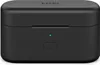 A black charging case for wireless earbuds, with a green indicator light and a button on the front. Produktbild-Vorschau