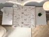 A top-down view of a changing table topper with a woodland animal print, placed on a white dresser. The scene is set in a nursery or child's room, with a rug and wooden floor visible. Podgląd zdjęcia produktu