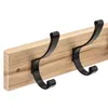 A close-up shot of a wooden coat rack with black metal hooks against a white background. Náhled obrázku produktu