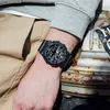 A person's arm wearing a black G-SHOCK watch is resting on a rusty metal surface. Anteprima dell’immagine prodotto