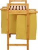 A close-up, front-facing view of a bamboo laundry basket with two yellow fabric bags. Produktbild-Vorschau