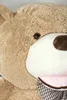 A close-up of a large teddy bear's face, showing its eye, nose, and mouth area, with a plaid bow tie. Podgląd zdjęcia produktu