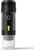 A black and white portable coffee maker with yellow and green accents, shown against a white background. Náhľad obrázku produktu