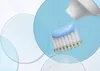 A close-up of a toothbrush with blue toothpaste being squeezed onto it. Produktbild-Vorschau