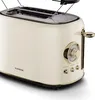 A close-up studio shot of a cream-colored retro toaster with gold accents. Podgląd zdjęcia produktu