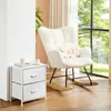 A cozy corner of a room with a white rocking chair and a white nightstand next to a window with a view of trees. Produktbild-Vorschau