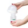 A person is pouring milk from a breast pump flange into a baby bottle. Produktbild-Vorschau