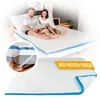 A couple is sitting on a bed with a mattress topper. Produktbild-Vorschau