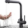 A black faucet with water running over hands. Produktbild-Vorschau