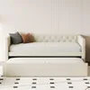 A cream-colored daybed with a pull-out trundle bed is shown in a room with a patterned rug. Produktbild-Vorschau