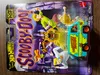 A Hot Wheels 'Scooby-Doo!' The Mystery Machine toy car in its packaging, with cartoon characters from the show depicted on the packaging. Produktbild-Vorschau