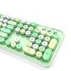 A close-up, angled view of a mint green keyboard with round, pastel-colored keys against a white background. Náhled obrázku produktu