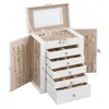 A white jewelry box with multiple drawers and side doors open, displaying jewelry. Produktbild-Vorschau