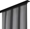 A close-up view of a gray curtain hanging from a black curtain rod. Náhled obrázku produktu